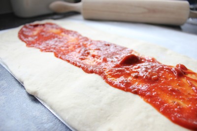 Spread pizza sauce on top of your calzone dough